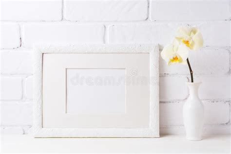 Download White frame mockup with soft yellow orchid in vase